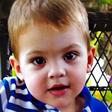 toddler boy with blonde hair and blue striped shirt